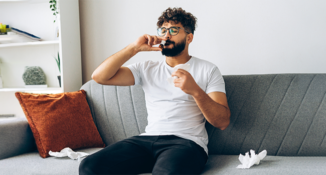  A man with alergy on his couch