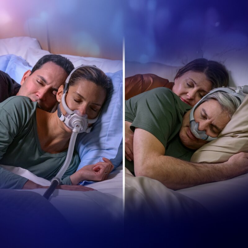 Mann mit einer AirFit N20 CPAP-Maske von Resmed, während seine Partnerin im Bett liest